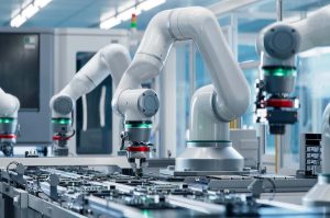 Robotic welding arm performing precision welds on automotive components at Michigan fabrication facility